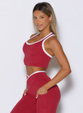 front left side view of a model wearing the Finish Line Tank in maroon color