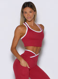 front right side view of a model wearing the Finish Line Tank in maroon color
