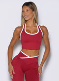 front view of a model looking to the right side wearing the Finish Line Tank in maroon color