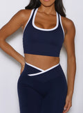 close up front view of a model wearing the Finish Line Tank in navy color