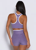 model captured from the back side wearing the Finish Line Tank in Violet color