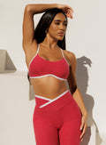 front profile view of a model in outdoors with hand resting on top of her head wearing the Finish Line Bra in Raspberry Punch color