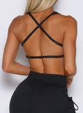 close up back profile view of a model wearing the FitBoost Bra in Black color