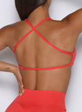 close up back profile view of a model wearing the FitBoost Bra in Command Red color