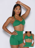 front profile view of a model showcasing the tied and non tied version of the front straps wearing the FitBoost Bra in Field Green color