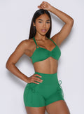 right side profile view of a model wearing the PocketBoost Shorts in Field Green color