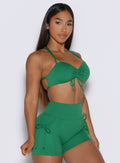 front right side profile view of a model wearing the FitBoost Bra in Field Green color