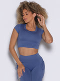 front profile view of a model wearing the FitBoost Tee in Blue slate color paired with the matching leggings