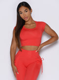 model with one hand on her waist captured from the front wearing the FitBoost Tee in command red color