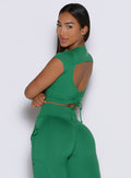 back left side profile view of a model wearing the FitBoost Tee in Field green color