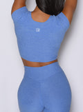 close up back profile view of a model wearing the Fit Fam Active Tee in Boss Blue color