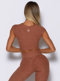 back profile view of a model wearing the Fit Fam Active Tee in spiced chai color