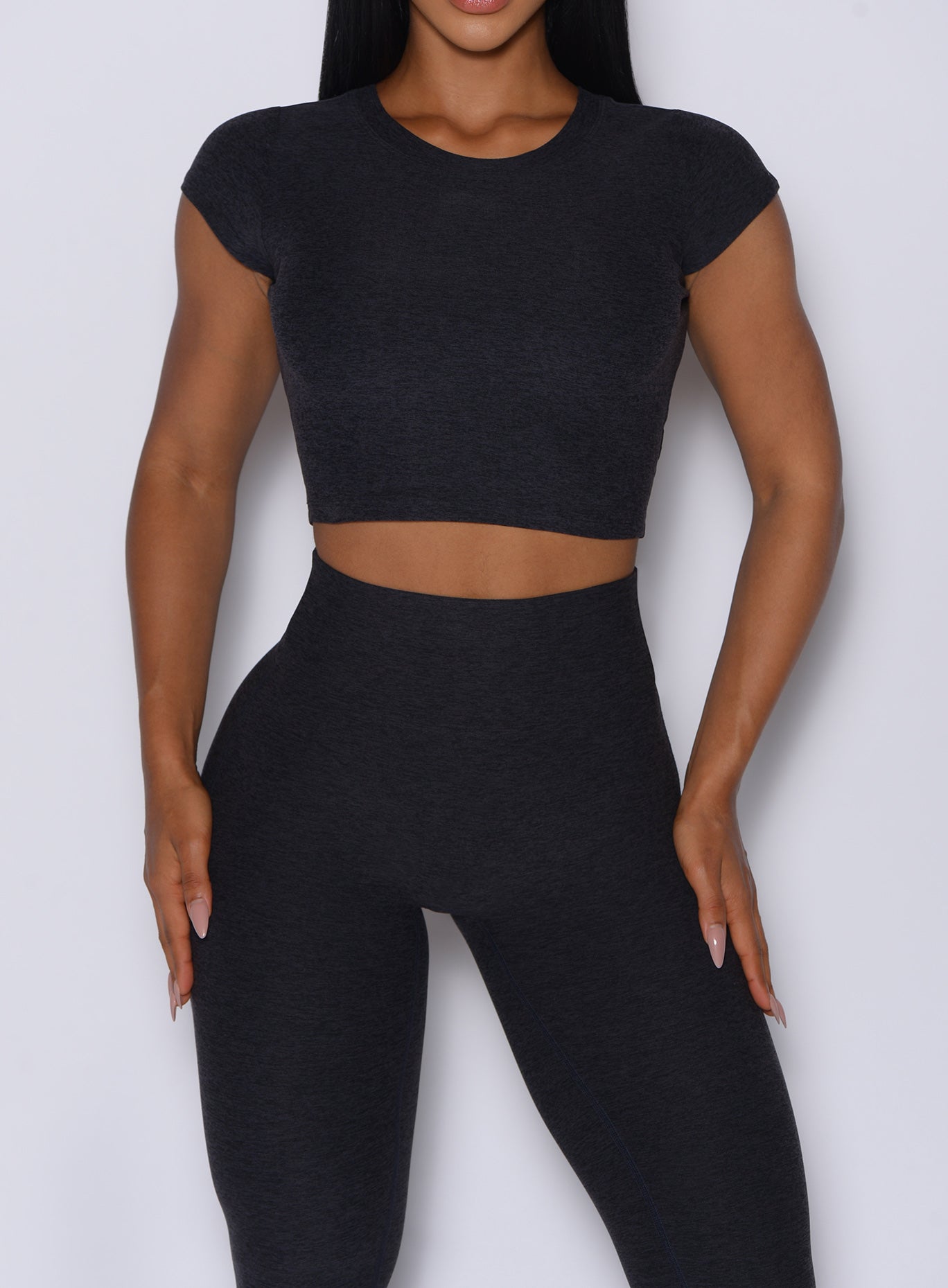 Cropped Onyx Fit Fam Active Tee in heathered black with cap sleeves for a versatile gym look.