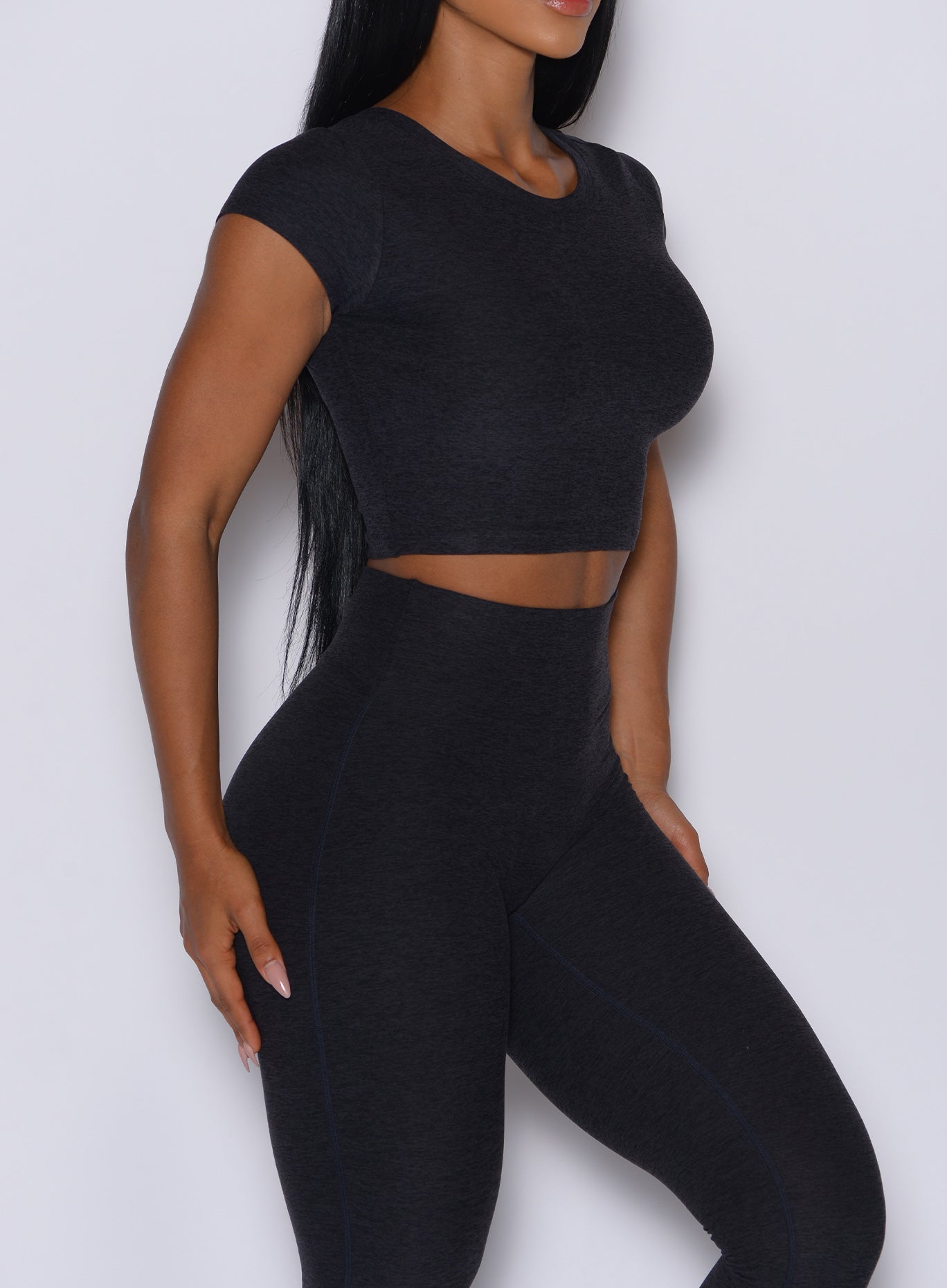 Heathered Onyx Fit Fam Active Tee with cap sleeves and a cropped waist for versatile gym styling.