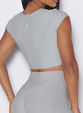 close up side profile view of a model wearing our Fit Fam Active Tee in cloud color along with the matching Leggings