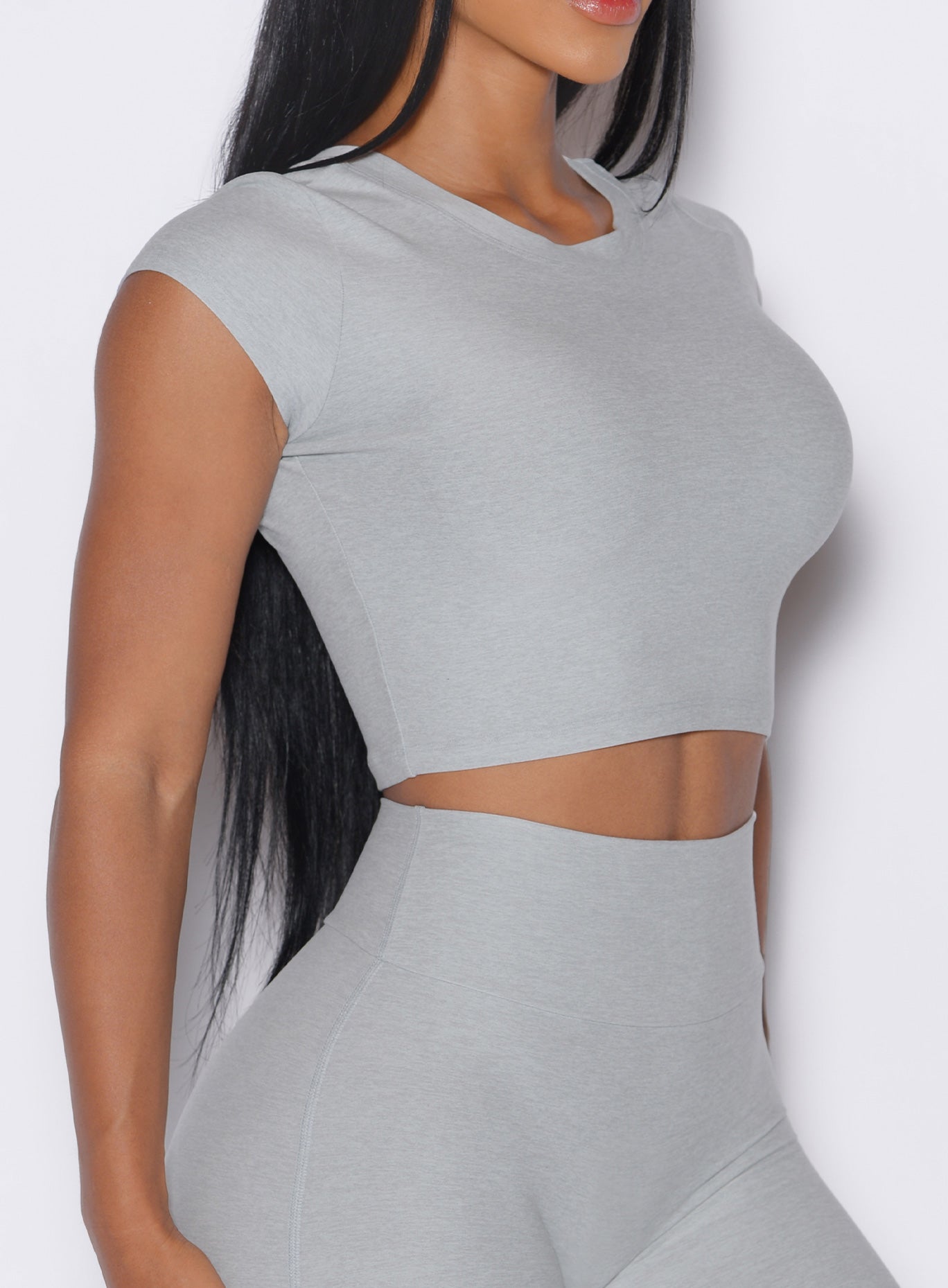 close up side profile view of a model wearing our Fit Fam Active Tee in cloud color along with the matching Leggings