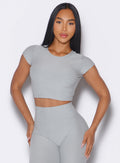 front profile view of a model wearing our Fit Fam Active Tee in cloud color along with the matching Leggings