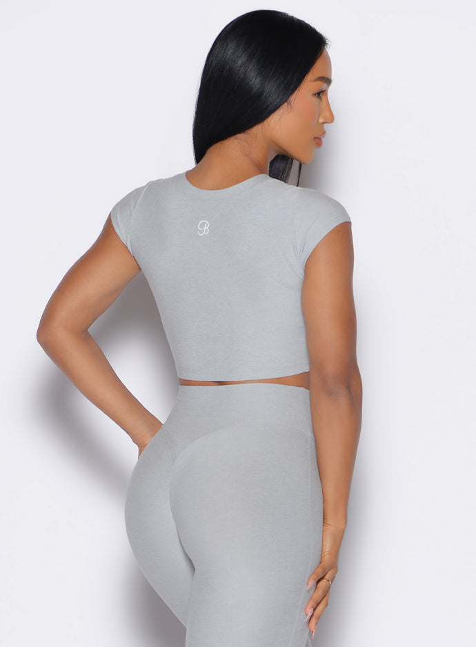 back profile view of a model wearing our Fit Fam Active Tee in cloud color along with the matching Leggings