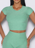 Cropped Fit Fam Active Tee in Sage; breathable heathered fabric for high-performance gym sessions.