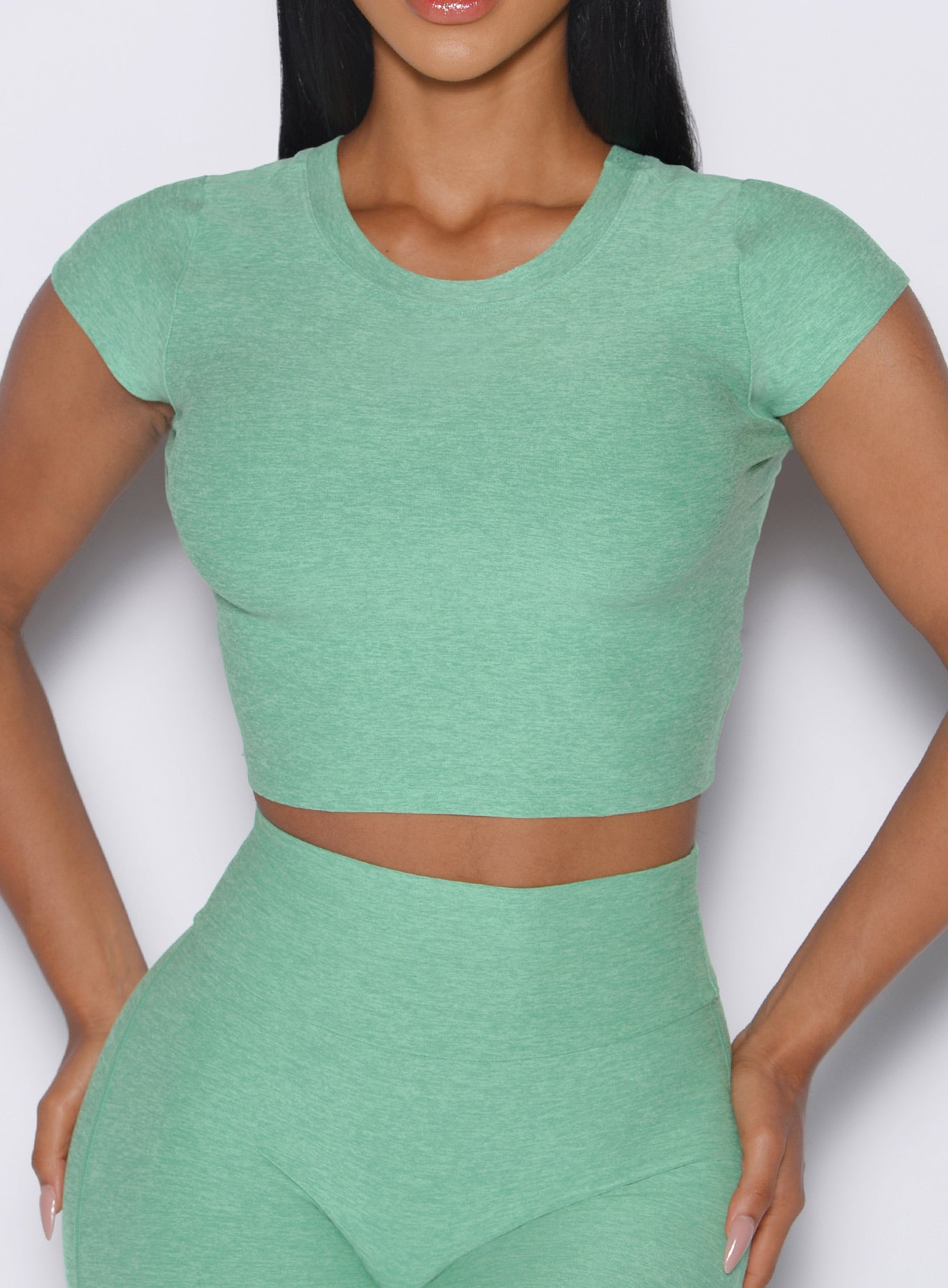 Cropped Fit Fam Active Tee in Sage; breathable heathered fabric for high-performance gym sessions.