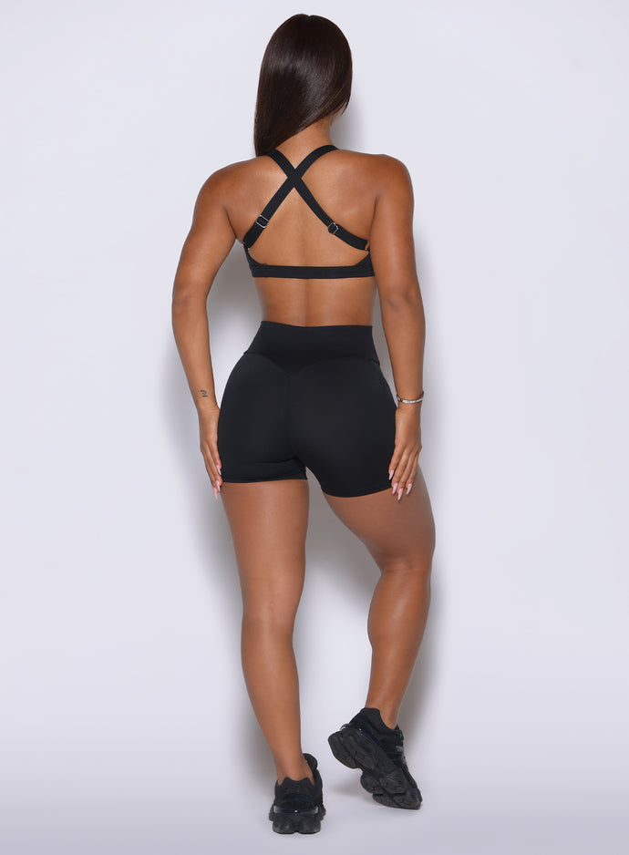 Rear angle shows a 3¾” inseam and a secure, non-sagging fit across the glutes in solid black