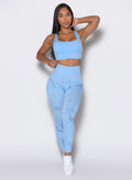 Front  profile view of a model wearing our fit marble leggings in Blue Jay color along with a matching bra