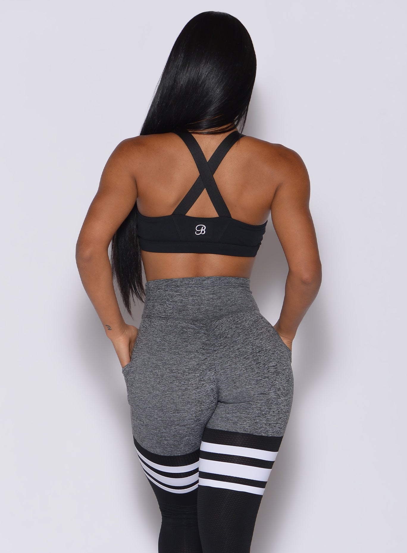 Black Glow Sports Bra featuring a supportive keyhole front and adjustable strappy back.