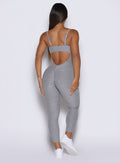 back profile of a model wearing the flawless form bodysuit in dark and stormy color