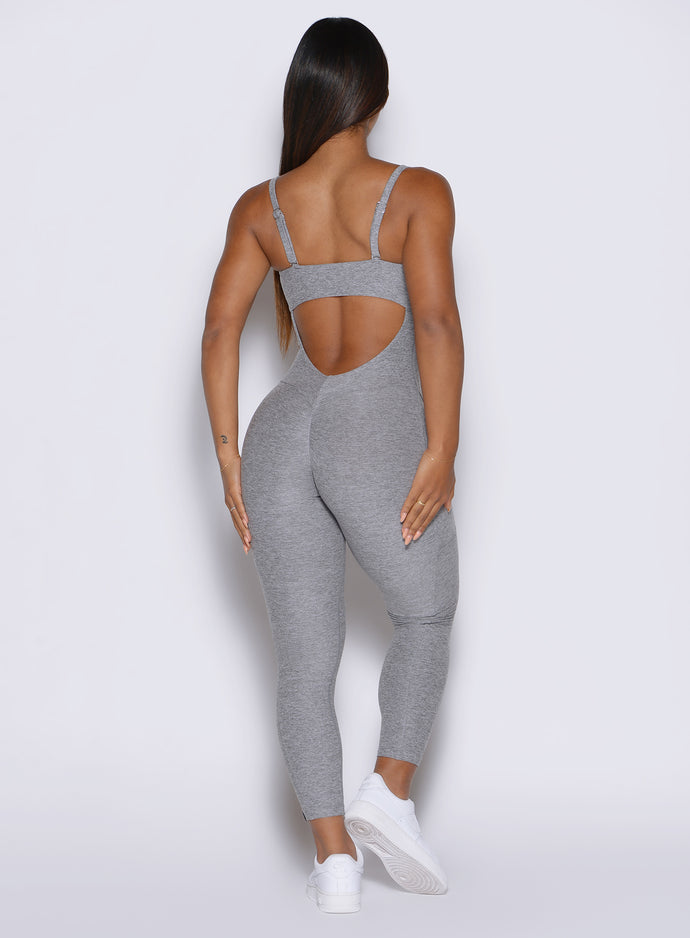 back profile of a model wearing the flawless form bodysuit in dark and stormy color