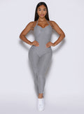 front view of a model with both hands on her waist wearing the flawless form bodysuit in dark and stormy color