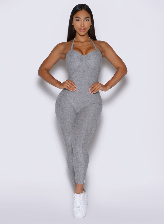 front view of a model with both hands on her waist wearing the flawless form bodysuit in dark and stormy color