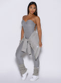 front view of a model with the Laidback luxe shirt tied around her waist wearing the flawless form bodysuit in dark and stormy color