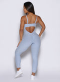 back side view of a model wearing the flawless form bodysuit in niagara mist color