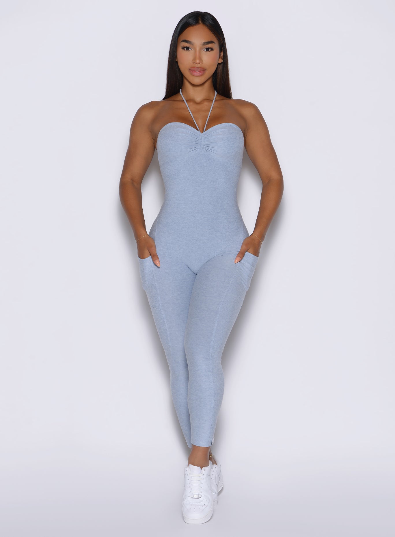front profile view of a model wearing the flawless form bodysuit in Niagara mist color