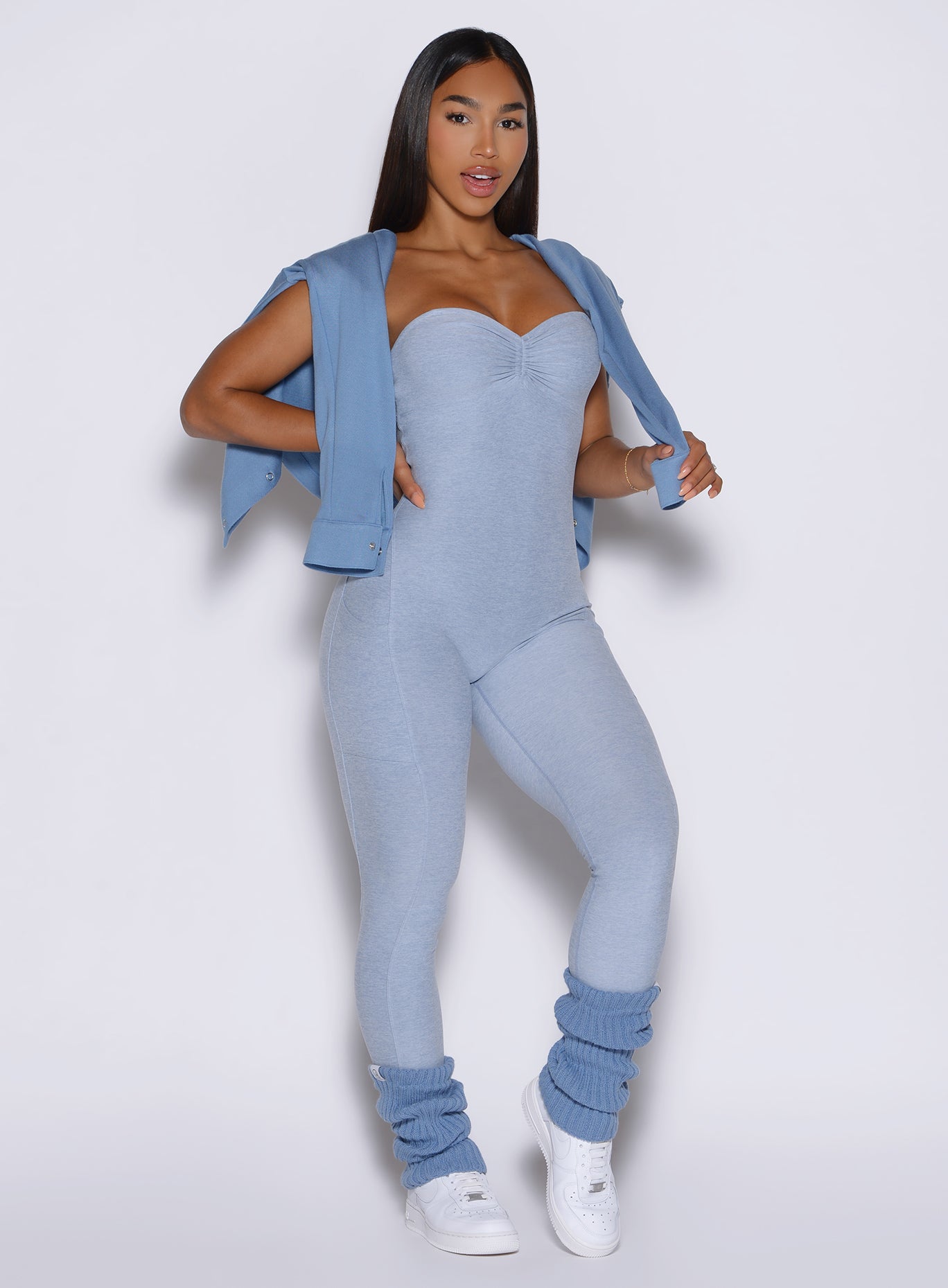 frontal view of a model wearing the flawless form bodysuit in Niagara mist color with the matching leg warmers 