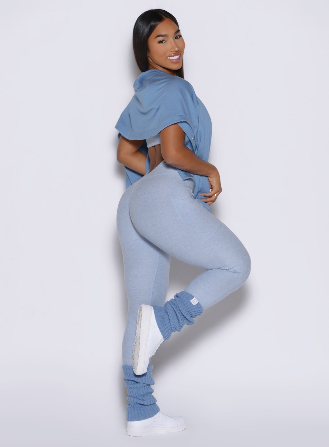 right side profile view of a model wearing the flawless form bodysuit in Niagara mist color