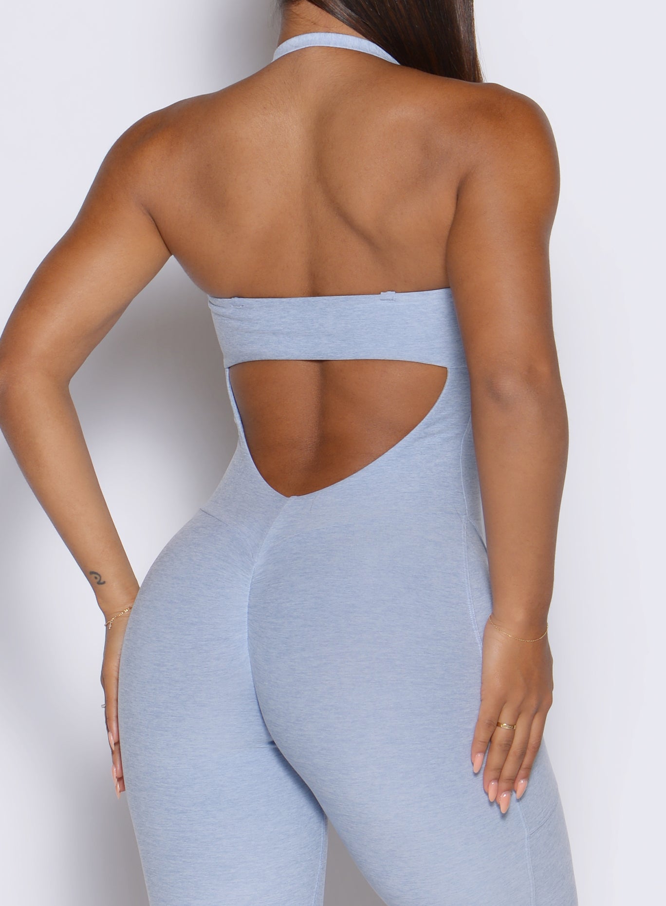 detailed back side view of a model wearing the flawless form bodysuit in niagara mist color