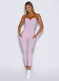 front profile view of a model wearing the flawless form bodysuit in pink paloma color