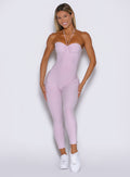 frontal view of a model wearing the flawless form bodysuit in pink paloma color