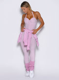 front view of a model with the laidback luxe shirt tied around her waist wearing the flawless form bodysuit in pink paloma color