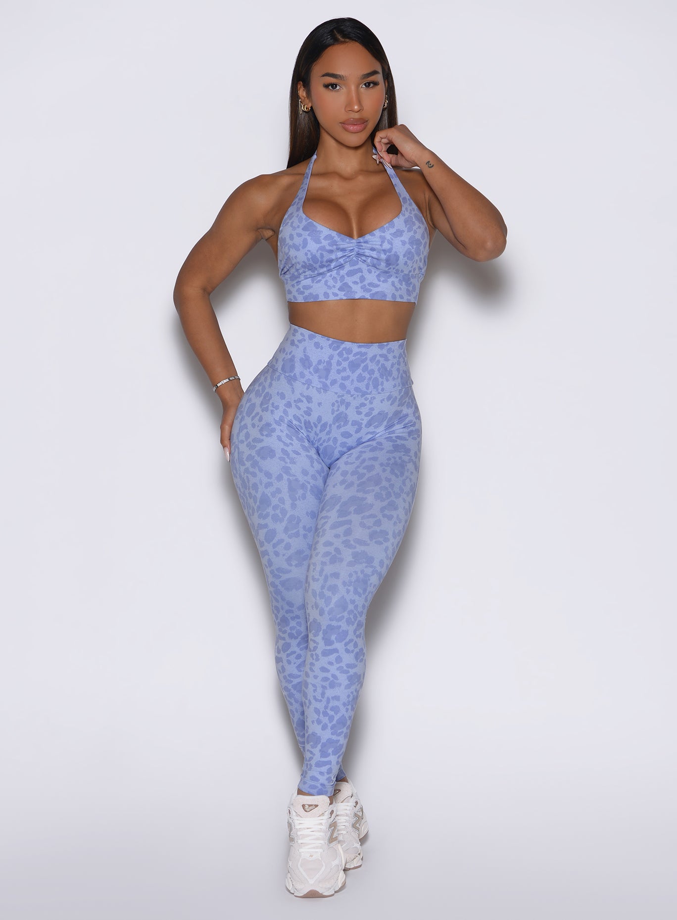 Front profile view of the model wearing our Flexfit leggings in Leopard Baby Lavender paired with a matching top.
