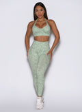 Front view showcasing the model in Leopard Cool Matcha Flexfit leggings and a matching bra.