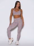 Front profile view of the model in our Flexfit leggings in Leopard Violet Ice paired with the matching top.