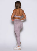 Back left profile view of the model in our Flexfit leggings in Leopard Violet Ice.