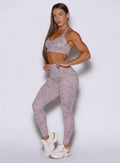 Front left side profile view of the model with both her hands on her waist wearing our Flexfit leggings in Leopard Violet Ice.