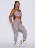 Front right side profile view of the model in our Flexfit leggings in Leopard Violet Ice paired with the matching top.