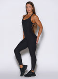 front left side shot of a model wearing the Form Bodysuit in Heathered Black color