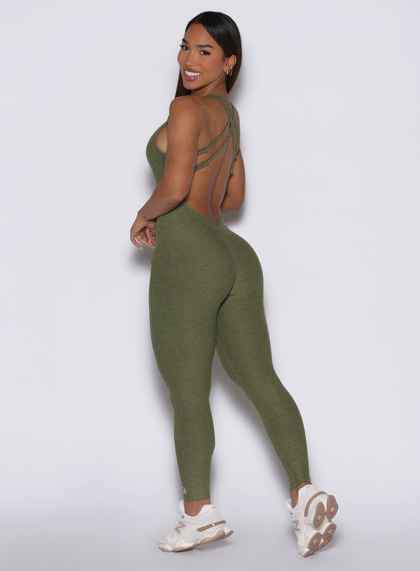 Lily Pad Form Bodysuit with a deep V back and sculpting crossover straps for gym performance.