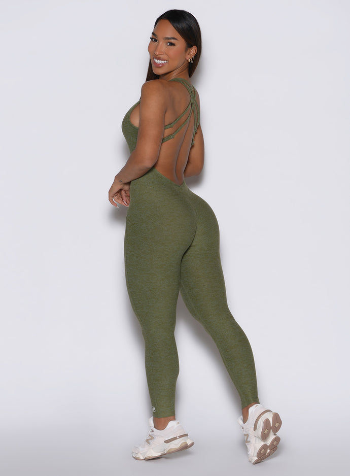 back left side profile view of a model looking over her shoulder wearing the Form Bodysuit in Lily Pad color