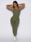 front profile view of a model with both hands behind her head wearing the Form Bodysuit in Lily Pad color
